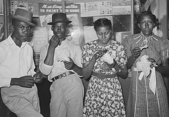 Negroes eating ice cream in front of hardware store  Farm Security Administration Archive Lee Russell
